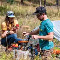 Man and women cooking with the Jetboil 8 Inch Ceramic Summit Skillet outdoors