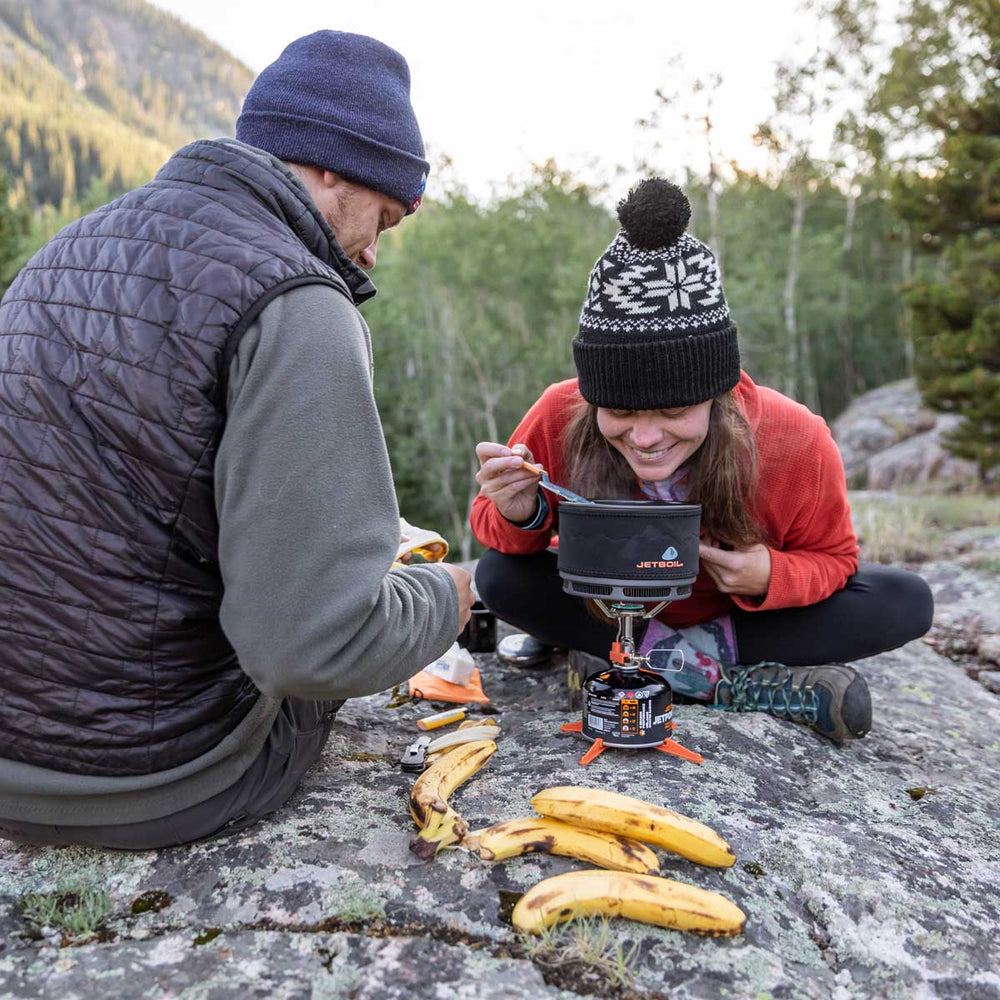 Man and women cooking with the Jetboil 1.5L Ceramic FluxRing Cook Pot