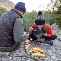 Man and women cooking with the Jetboil 1.5L Ceramic FluxRing Cook Pot