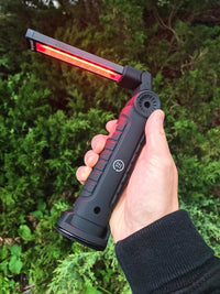 hand holding 72HRS LED Work Light with red light on