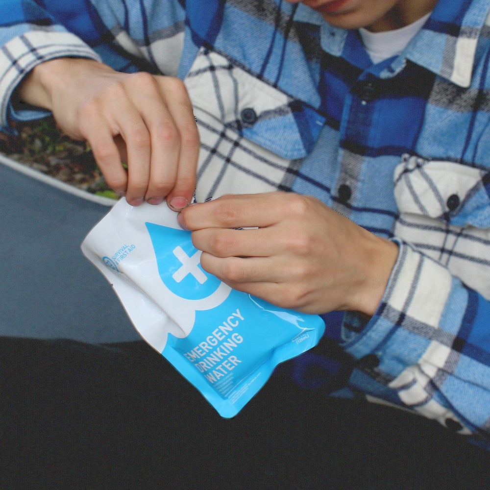 man opening 72HRS water pouch