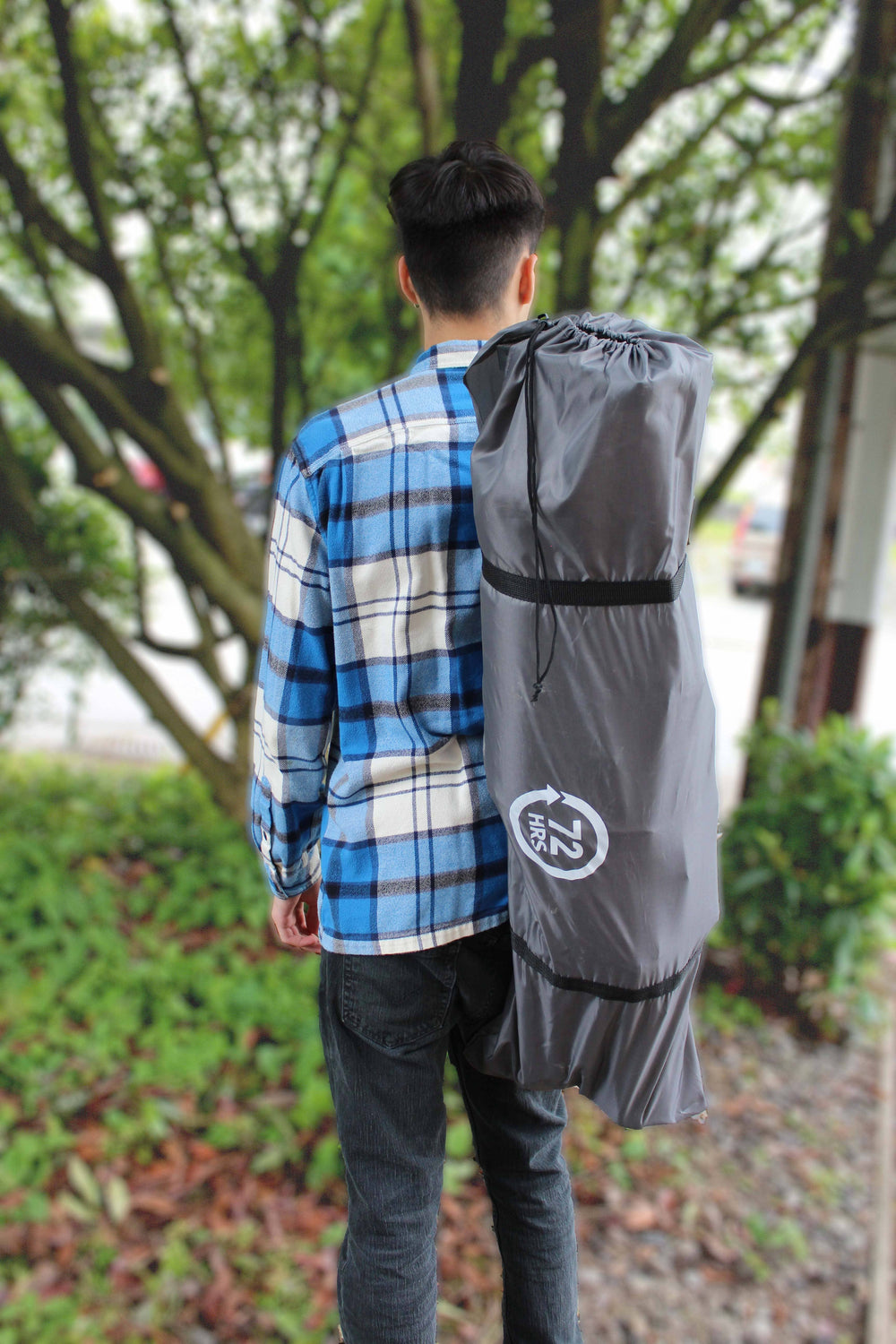man carrying Portable Camping Cot - 72HRS