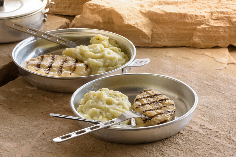 chicken and mashed potaties served in a metal plate