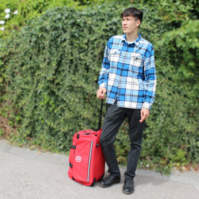 man standing with 72HRS Rolling Duffel Bag