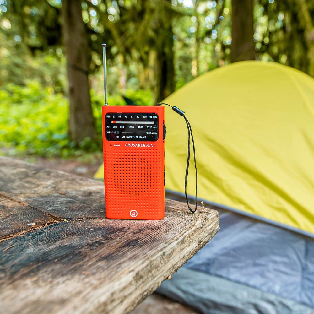 crusader mini red on table with tent in background