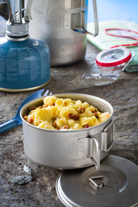 scrambled eggs with bacon served in metal bowl