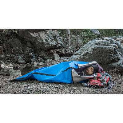 man sleeping in Heavy Duty Emergency Sleeping Bag (Single Person) outdoors
